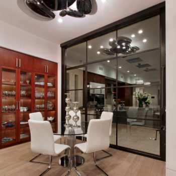 Contemporary office with Euroline Steel Windows and Doors specialty doors opening to a night view.