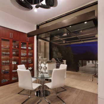 Euroline Steel Windows and Doors specialty doors in a luxurious wine room with night view.