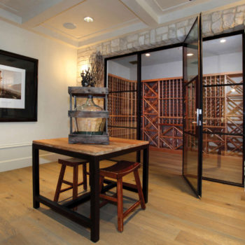 Euroline Steel Windows and Doors wine room doors in a chic residential dining space.