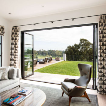Euroline Steel Windows and Doors sliding door in a contemporary living room with garden access.