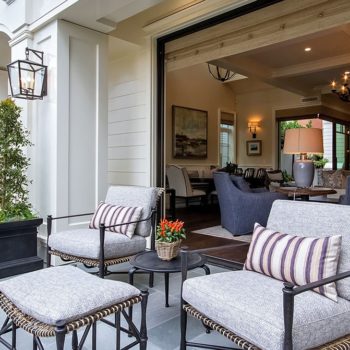 Euroline Steel Windows and Doors pivot door leading to a cozy patio.
